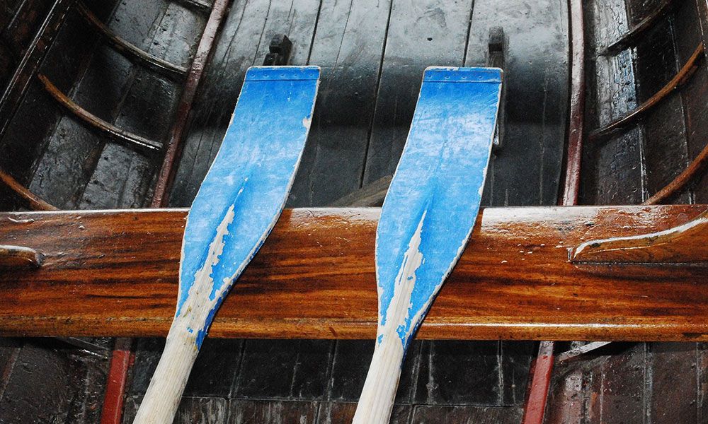 Blue oars lying in a boat