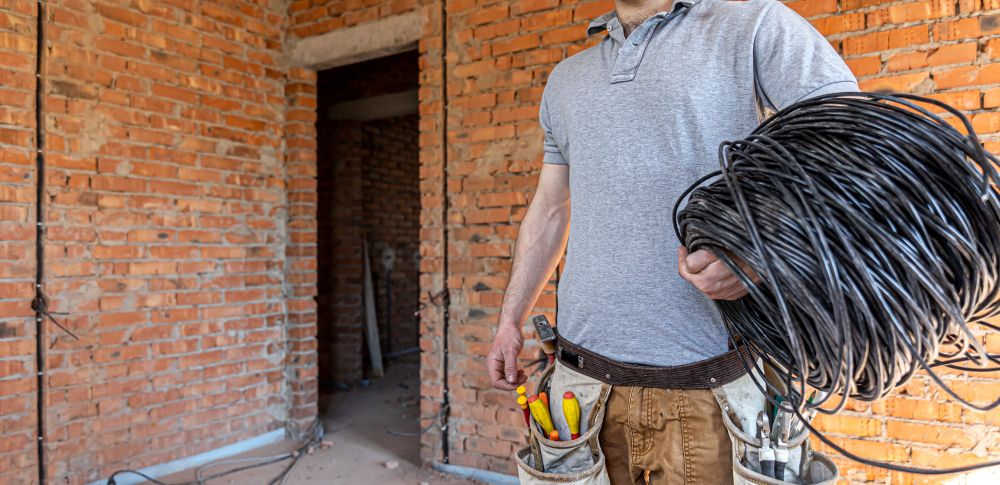 Electrician holds electric cables