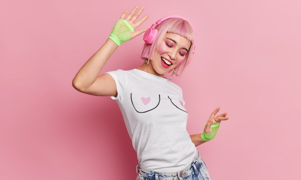 Girl with pink hair listens to music