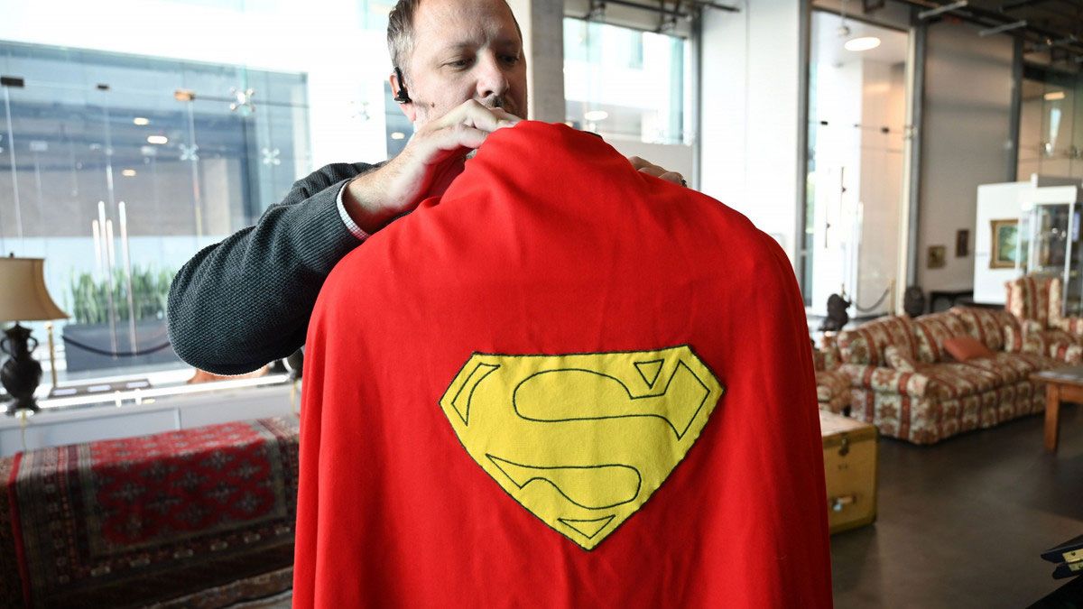 The man holds the superman cape