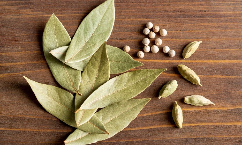 Top view of bay leaves with pepper