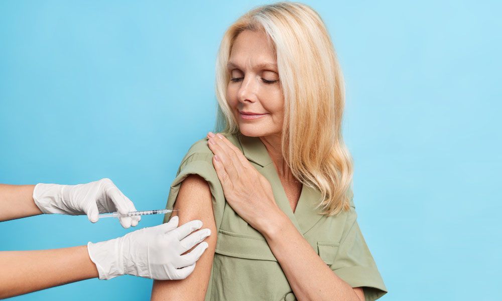 Woman with light hair looks at the injection process
