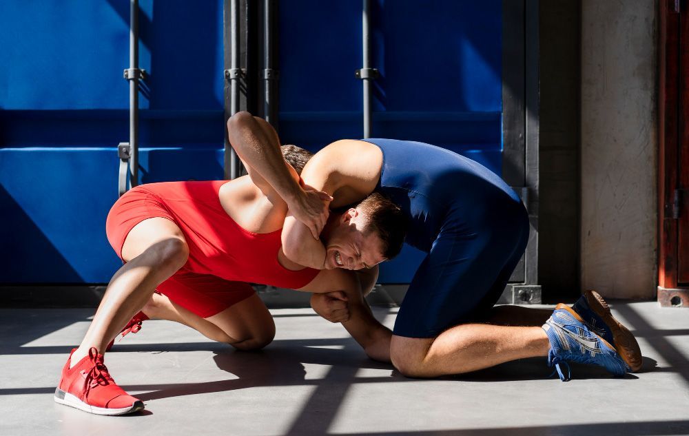 Young men in sportswear demonstrating wrestling combat